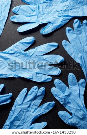 Latex gloves on a black table.