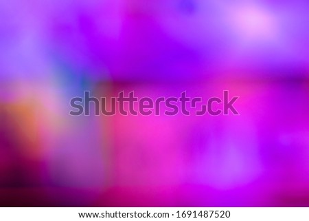 Defocused photo in blue and pink tones. Abstract blurred background. Space for lettering or design
