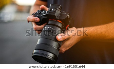 Photographer Holding a DSLR Camera