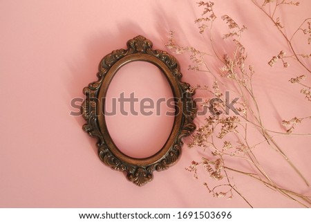 Retro picture frame mockup. Round frame on pink background.