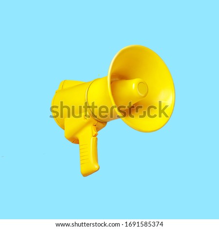 Yellow megaphone loudspeaker on a blue background Royalty-Free Stock Photo #1691585374