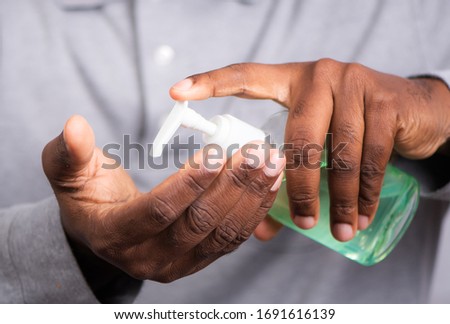 Corona Virus Protection. Hands using hand sanitizer gel pump dispenser. Health concept for killing germs, bacteria, virus, Lockdown, Flatten the Curve, Social Distancing, State of Emergency Royalty-Free Stock Photo #1691616139