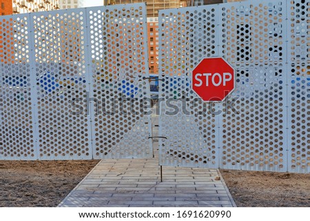 A stop sign on a locked gate because of the quarantine diseases of coronavirus