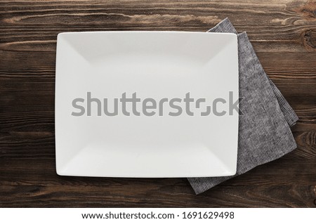 Plate and Napkin. On Wooden background. Copy free space