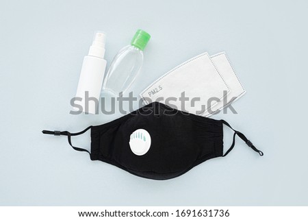 Reusable antiviral masks with breather filter valve and hand sanitizer. Cotton  masks with activated carbon filter.  Protection against flu and coronavirus, pollution, virus. Personal hygiene   Royalty-Free Stock Photo #1691631736