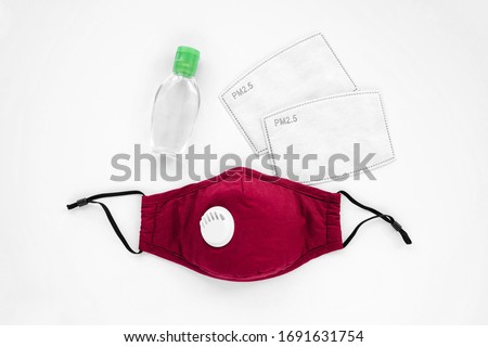 Reusable antiviral masks with breather filter valve and hand sanitizer. Cotton  masks with activated carbon filter.  Protection against flu and coronavirus, pollution, virus. Personal hygiene   Royalty-Free Stock Photo #1691631754