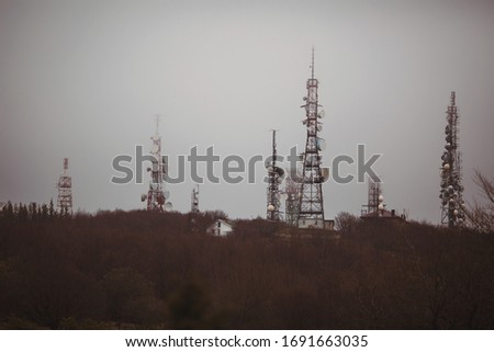 antennas on the mountain with rain clouds background