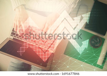 Double exposure of woman hands working on computer and arrows hologram drawing. Top View. growth concept.