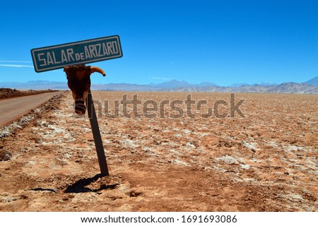 The sign says: "Arizaro salt flat". Salta, Argentina