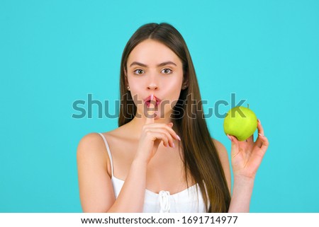 Womans secrets. Losing weight, diets and healthy lifestyle concept. Weight loss, slim body, healthy lifestyle concept. Portrait beautiful girl with apple on blue background. Royalty-Free Stock Photo #1691714977