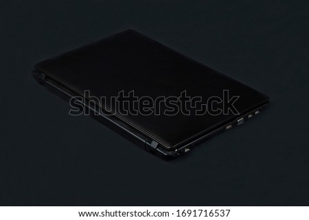 Black laptop on a grey background.Office equipment.