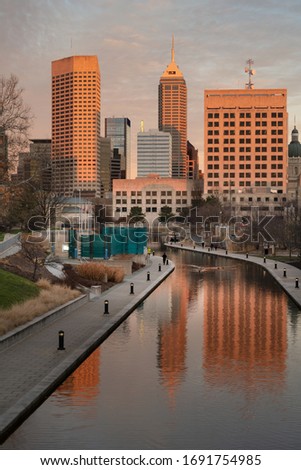Indianapolis city skyline and canal with the warm sunshine of late afternoon.