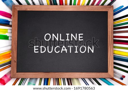 Online education banner. Chalkboard with pencils on background.