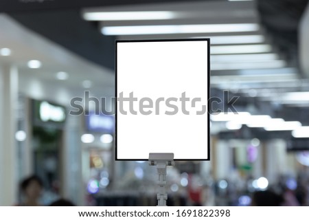 mockup white poster stand in front of blur background for show or present promotion product concept