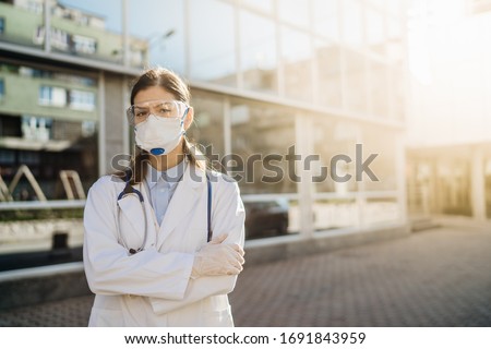 Epidemiologist in front of isolation hospital facility.Coronavirus Covid-19 heroes.Mental strength of medical professional.Emergency room doctor prepared for virus outbreak.Brave physician Royalty-Free Stock Photo #1691843959