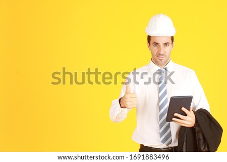 Handsome and smart businessman white shirt hand holding smartphone smiling and Thumbs up isolated on yellow background. Copy Space