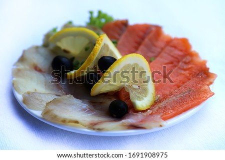 Salted chum salmon and halibut with olives dishes of Russian national cuisine, restaurant, serving