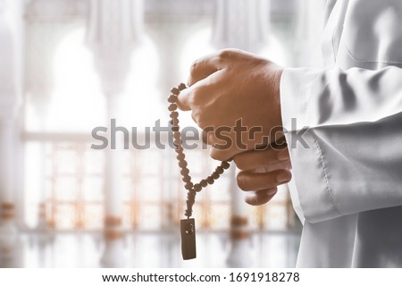 Religious muslim man praying with rosary beads Royalty-Free Stock Photo #1691918278