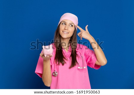 Young doctor with a pink uniform on a blue background