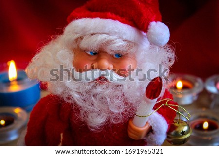 The Christmas Theme. Santa Claus With A Candle In His Hand.
