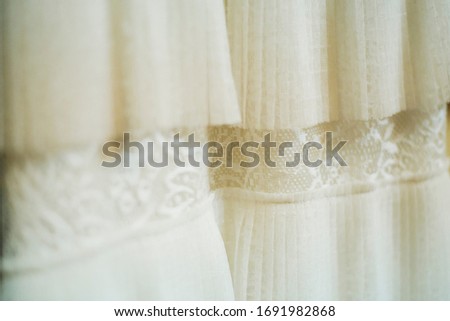 Picture with cream wool and lace pleated fabric. Clothes