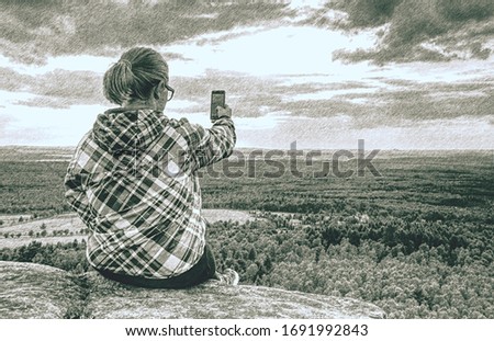 Portrait of woman taking a picture at the beautiful mountains background.  Dashed pencil sketch effect. 