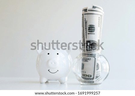 Piggy bank and dollar banknotes on the table save money into a growing business for success and save for retirement.