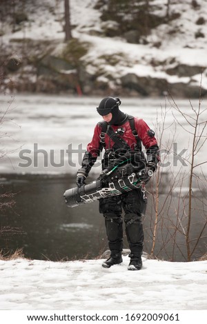 Scuba diver with rebreather after the dive in frozen quarry in the middle of Europe Royalty-Free Stock Photo #1692009061