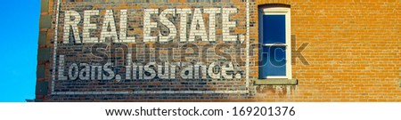Old Real Estate, Loans and Insurance sign on red brick building, Fort McLeod Alberta