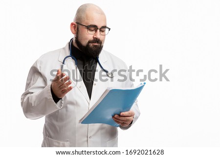 Bald male doctor in a white coat with a medical history in his hands. Quarantine during the coronavirus pandemic. Isolated on a white background. Space for text.
