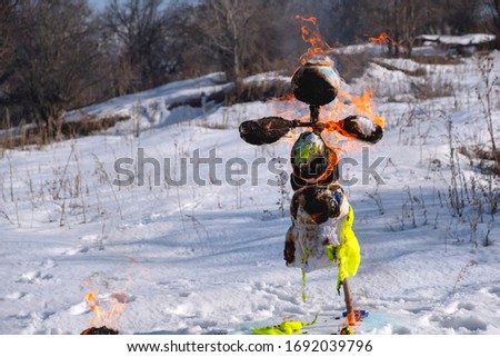 Burning scarecrow on festival maslenitsa. Slavic national spring pagan festival - Maslenitsa. Burning effigies straw on traditional holiday dedicated to spring - slavic celebration shrovetide
