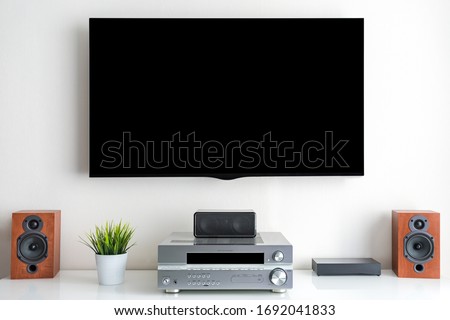 Home entertainment multimedia center in living room: tv, audio system and over devices Royalty-Free Stock Photo #1692041833