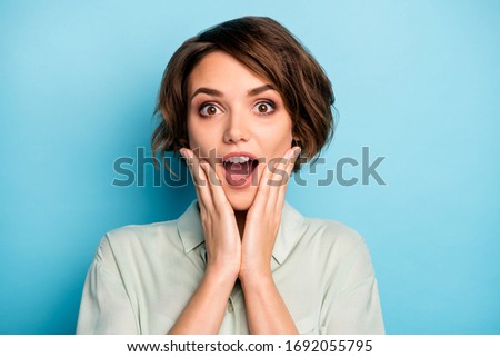 Closeup photo of attractive business lady short hairdo good mood open mouth listen boss promoted her arms on cheeks wear casual green shirt isolated blue color background