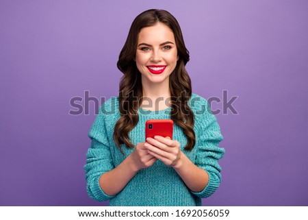 Photo of pretty lady hold telephone writing new post youth popular blog browsing multimedia documents wear blue knitted pullover isolated purple color background