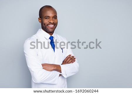 Photo of cheerful doctor dark skin guy virologist agent corona virus seminar conference arms crossed toothy smiling wear white lab coat tie isolated grey color background