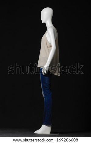 Side view mannequin dressed in shirt and jeans on black background
