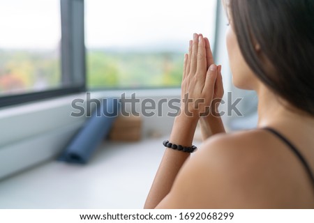 Yoga woman meditating at home for stress free serenity with prayer hands wellness zen calm. Royalty-Free Stock Photo #1692068299