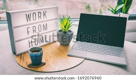 Working from home remote work inspirational social media lightbox message board next to laptop and coffee cup for COVID-19 quarantine closure of all businesses.