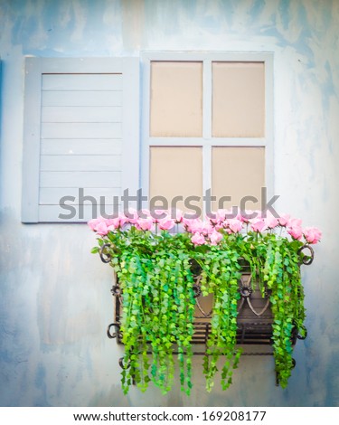 Old windows and flowers box , process in vintage style picture