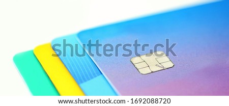Stack of multicolored credit cards collection on white background. Credit card chip for secure payment.