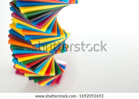 spiral Stack of different colours Cast Acrylic Sheet on white background