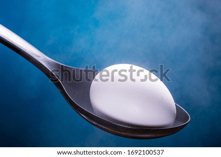 white shell hard boiled egg egg on spoon