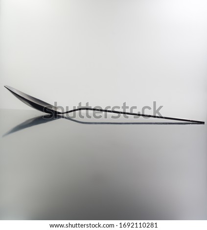 spoon with shadow, back light, isolated in white background