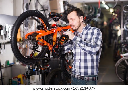 concentrated male mounts bicycle parts for assembly bike in sports shop Royalty-Free Stock Photo #1692114379