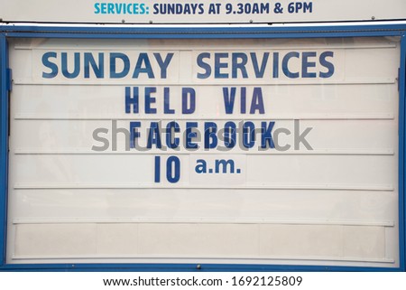 Church closed because of Coronavirus pandemic. Sign stating online Sunday service via Facebook.