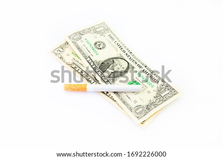 Banknotes and a cigarette on a white background
