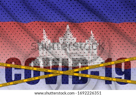 Cambodia flag and Covid-19 inscription with orange quarantine border tape. Coronavirus or 2019-nCov virus concept