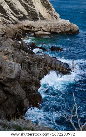 man on the background of the sea. rocks on the background of the sea