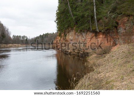 City Cesis, Latvia. River in spring with sandstone cliffs and caves.02.04.2020