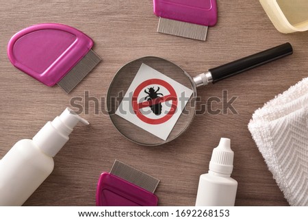 Products and equipment for treating lice on a wood table detail. Horizontal composition. Top view